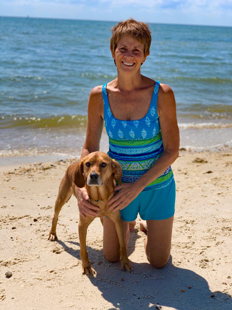 Kim taking one of her daily Cape Charles Beach walks with her dog, Hannah.