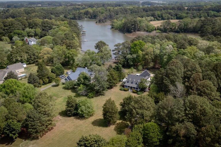 Aerial view of waterfront homes along a tidal creek in Cape Charles Virginia — flood insurance Virginia buyers guide