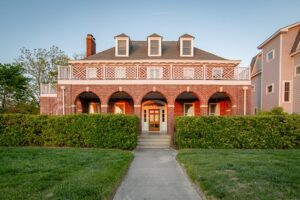 Historic brick home with arched front porch in Cape Charles, ideal for buyers considering buying a historic home in Cape Charles