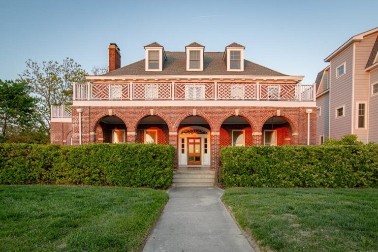 Historic brick home with arched front porch in Cape Charles, ideal for buyers considering buying a historic home in Cape Charles