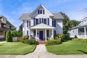 Historic District home with blue shutters and front porch at 615 Tazewell Ave Cape Charles Virginia — best neighborhoods for waterfront living in Cape Charles