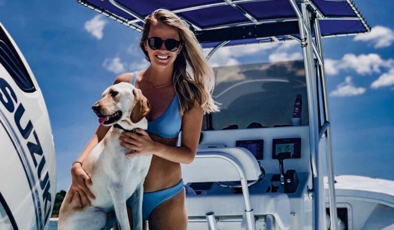 Woman and dog enjoying a day boating on the Chesapeake Bay near Cape Charles, part of the waterfront homes in Cape Charles lifestyle