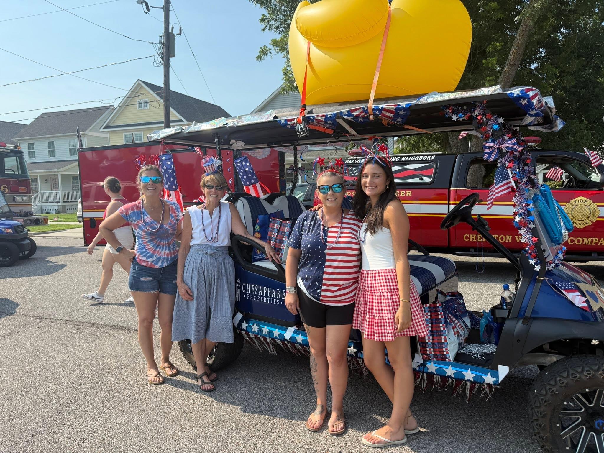 Chesapeake Properties team with their patriotic decorated golf cart at the Cape Charles Fourth of July parade, one of the top July events in Cape Charles